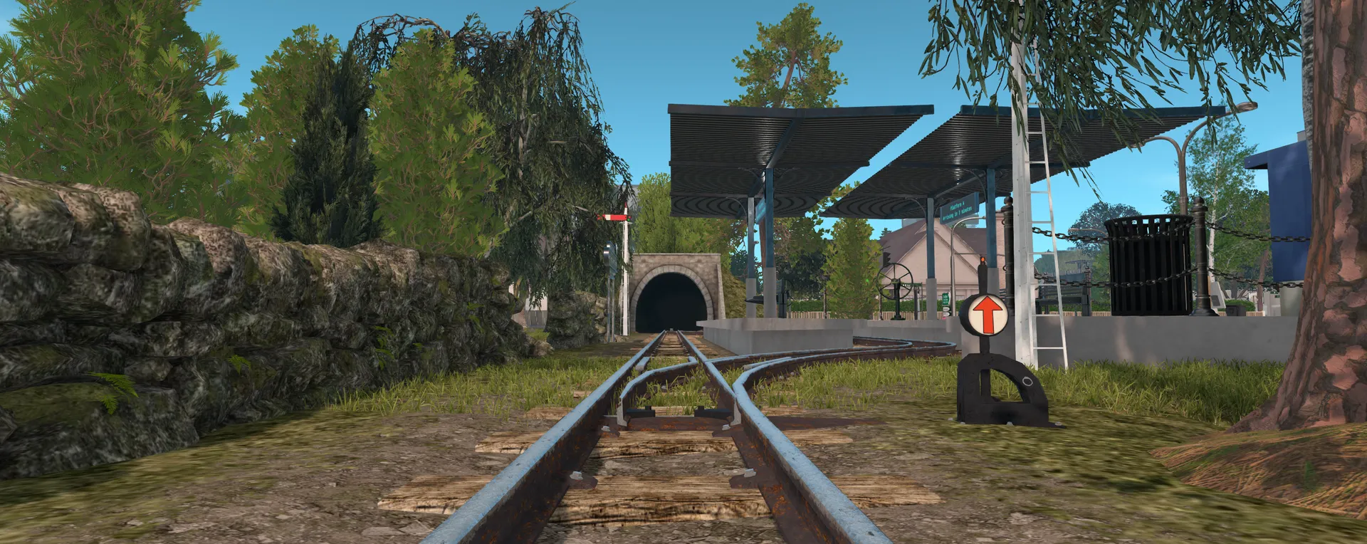 Railway tracks leading to a tunnel under the hill